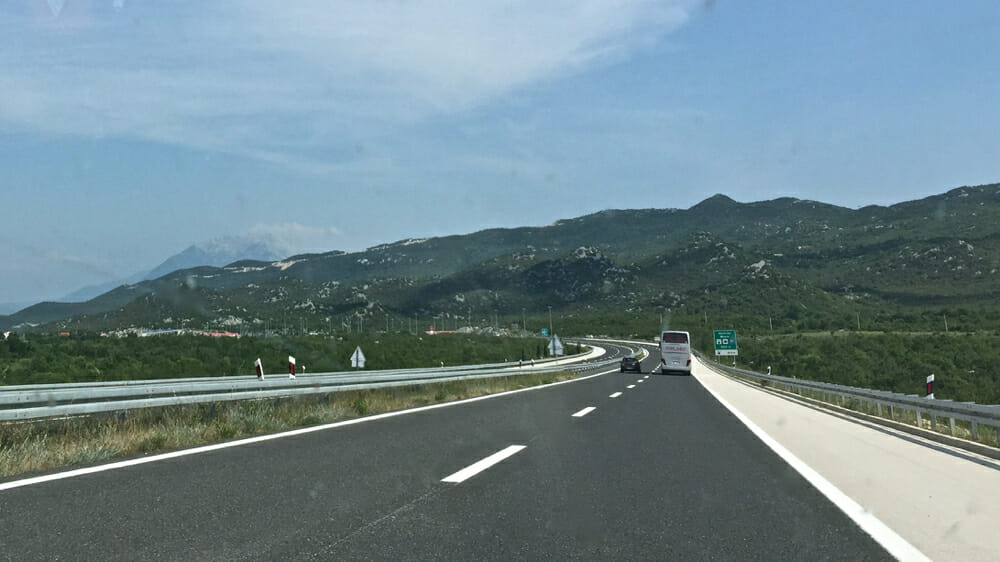 car passing a bus on highway