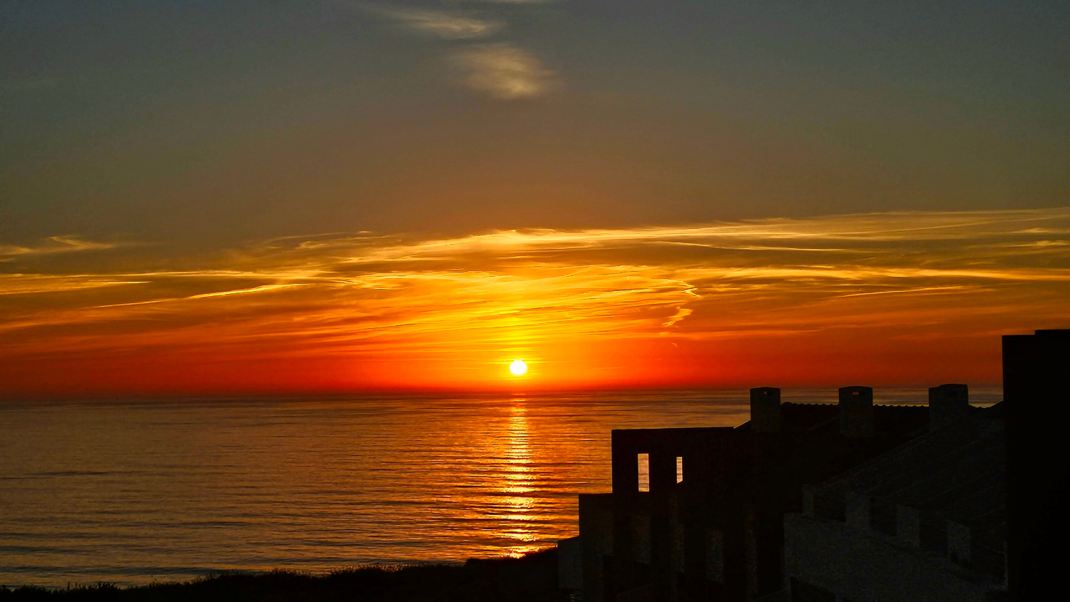 sunset over the water in Portugal