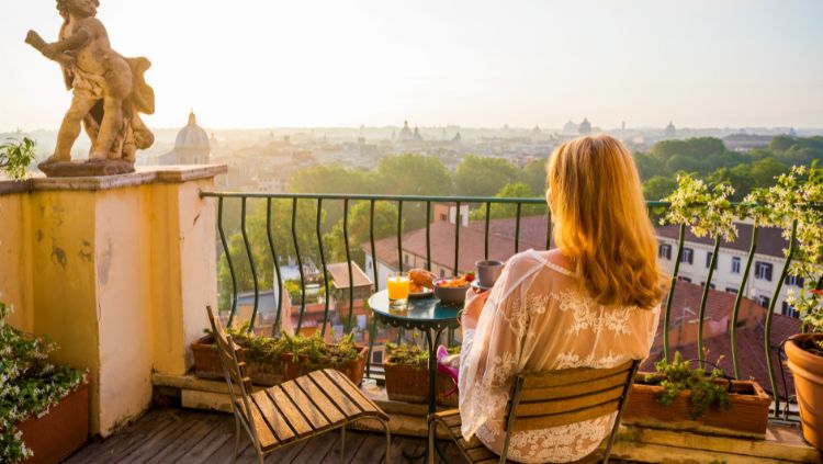 Solo house sitter taking in the view from an apartment balcony