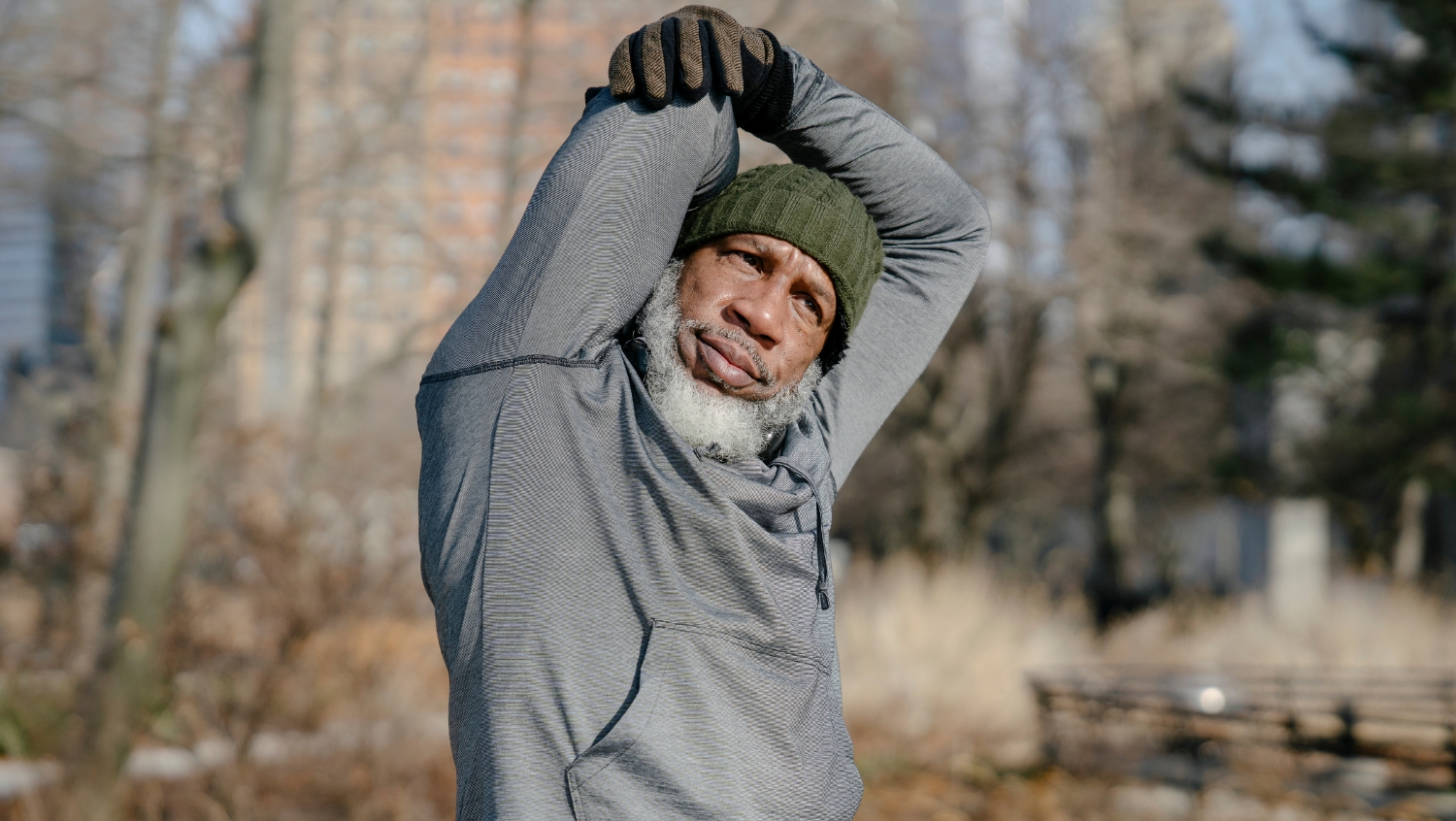 A senior solo traveler doing stretches before a hike